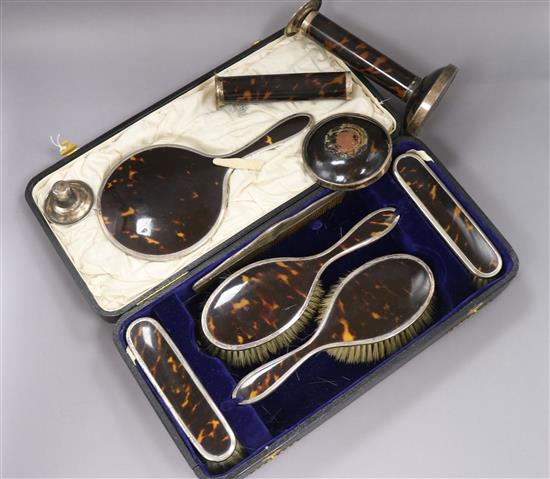 A cased silver and tortoiseshell dressing set and a pair of candlesticks